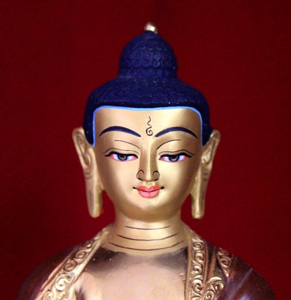 shakyamuni buddha statue gold painted face